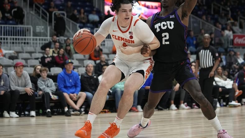 Dec 9, 2023; Toronto, Ontario, CAN; Clemson Tigers forward Ian Schieffelin (4) drives to the net against TCU Horned Frogs forward Emanuel Miller (2) during the second half at Coca-Cola Coliseum. Mandatory Credit: John E. Sokolowski-USA TODAY Sports