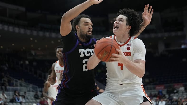 Dec 9, 2023; Toronto, Ontario, CAN; Clemson Tigers forward Ian Schieffelin (4) goes to shoot as TCU Horned Frogs forward JaKobe Coles (21) defends during the second half at Coca-Cola Coliseum. Mandatory Credit: John E. Sokolowski-USA TODAY Sports