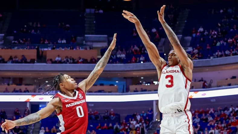 Oklahoma guard Otega Oweh (3) shoots three over Arkansas guard Khalif Battle (0) in the second half during an NCAA basketball game between the Oklahoma Sooners and the Arkansas Razorbacks at the BOK Center in Tulsa, Okla., on Saturday, Dec. 9, 2023.