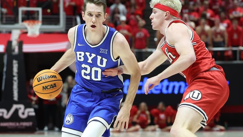Dec 9, 2023; Salt Lake City, Utah, USA; Brigham Young Cougars guard Spencer Johnson (20) drives against Utah Utes guard Hunter Erickson (0) during the first half at Jon M. Huntsman Center. Mandatory Credit: Rob Gray-USA TODAY Sports