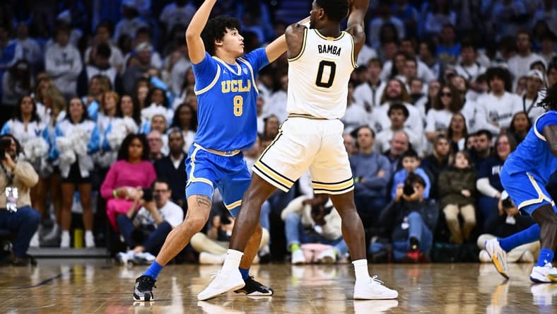 Dec 9, 2023; Philadelphia, Pennsylvania, USA; UCLA Bruins guard Ilane Fibleuil (8) defends Villanova Wildcats guard TJ Bamba (0) in the first half at Wells Fargo Center. Mandatory Credit: Kyle Ross-USA TODAY Sports