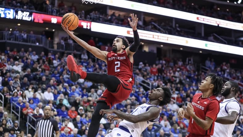 Dec 9, 2023; Newark, New Jersey, USA; Rutgers Scarlet Knights guard Noah Fernandes (2) drives past Seton Hall Pirates guard Kadary Richmond (1) for a layup in the first half at Prudential Center. Mandatory Credit: Wendell Cruz-USA TODAY Sports