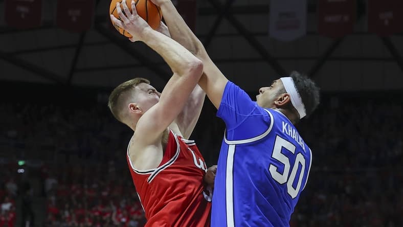 Dec 9, 2023; Salt Lake City, Utah, USA; Brigham Young Cougars center Aly Khalifa (50) blocks the shot of Utah Utes center Lawson Lovering (34) during the second half at Jon M. Huntsman Center. Mandatory Credit: Rob Gray-USA TODAY Sports
