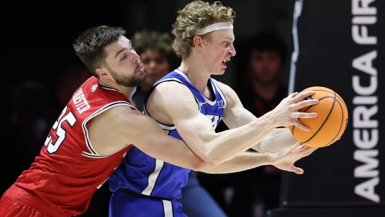 Dec 9, 2023; Salt Lake City, Utah, USA; Utah Utes guard Rollie Worster (25) and Brigham Young Cougars guard Richie Saunders (15) battle for the ball during the second half at Jon M. Huntsman Center. Mandatory Credit: Rob Gray-USA TODAY Sports