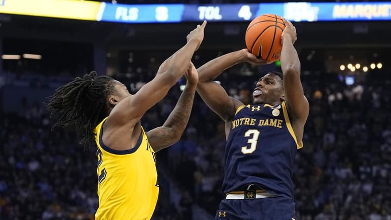 Dec 9, 2023; Milwaukee, Wisconsin, USA; Notre Dame Fighting Irish guard Markus Burton (3) shoots against Marquette Golden Eagles guard Sean Jones (22) during the first half at Fiserv Forum. Mandatory Credit: Jeff Hanisch-USA TODAY Sports
