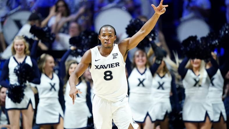 Dec 9, 2023; Cincinnati, Ohio, USA; Xavier Musketeers guard Quincy Olivari (8) reacts after a made three-point basket in the second half against the Cincinnati Bearcats at Cintas Center. Mandatory Credit: Albert Cesare/The Enquirer-USA TODAY Sports
