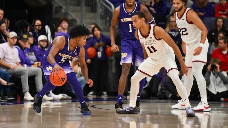 Dec 9, 2023; Seattle, Washington, USA; Gonzaga Bulldogs guard Nolan Hickman (11) guards Washington Huskies guard Sahvir Wheeler (5) during the second half at Alaska Airlines Arena at Hec Edmundson Pavilion. Mandatory Credit: Steven Bisig-USA TODAY Sports.