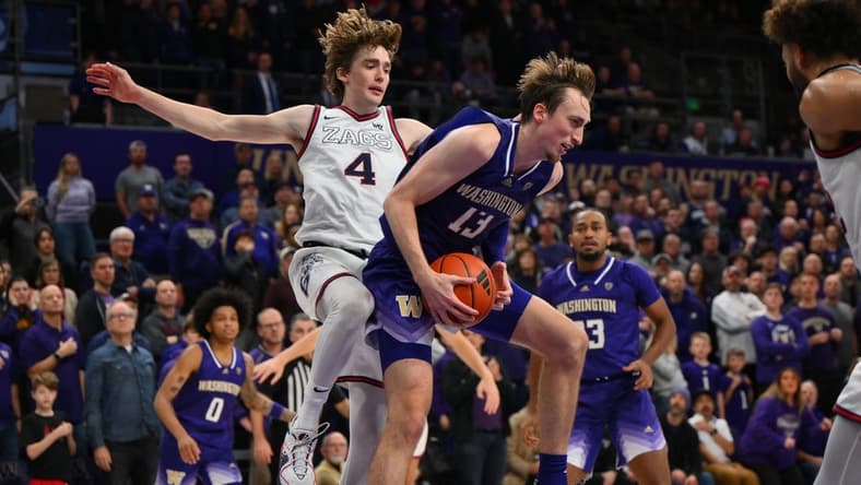 Dec 9, 2023; Seattle, Washington, USA; Washington Huskies forward Moses Wood (13) rebounds the ball in front of Gonzaga Bulldogs guard Dusty Stromer (4) during the second half at Alaska Airlines Arena at Hec Edmundson Pavilion. Mandatory Credit: Steven Bisig-USA TODAY Sports