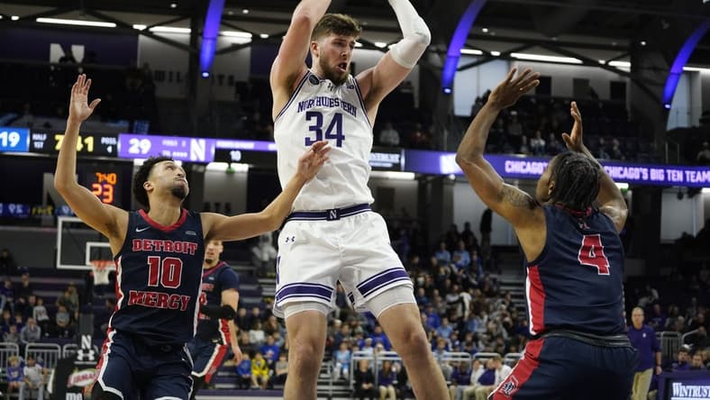 Dec 10, 2023; Evanston, Illinois, USA;Northwestern Wildcats center Matthew Nicholson (34) grabs a reboundd in front of Detroit Mercy Titans guard Marcus Tankersley (4) and guard Jamail Pink (10) during the first half at Welsh-Ryan Arena. Mandatory Credit: David Banks-USA TODAY Sports