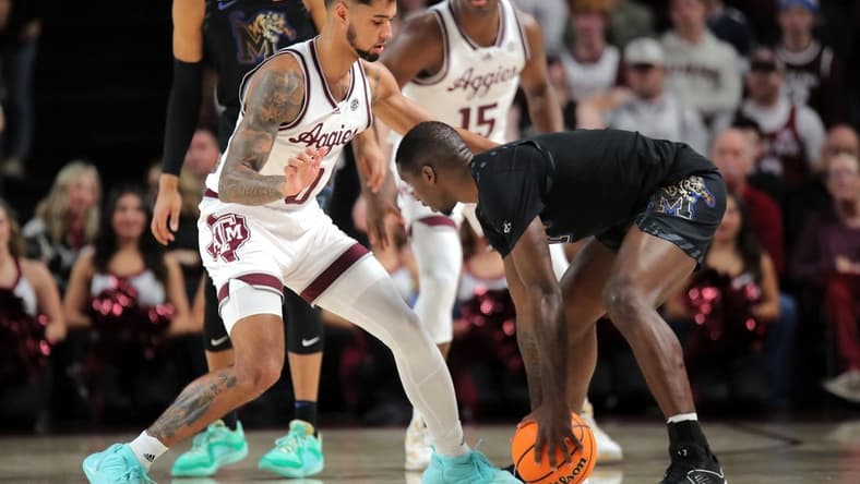 Dec 10, 2023; College Station, Texas, USA; Memphis Tigers forward David Jones (8) handles the ball against Texas A&M Aggies guard Jace Carter (0) during the first half at Reed Arena. Mandatory Credit: Erik Williams-USA TODAY Sports