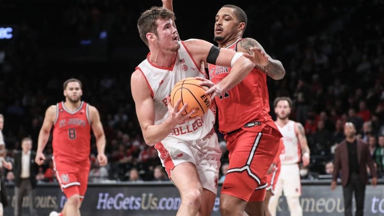 Dec 10, 2023; Brooklyn, New York, USA; Boston College Eagles forward Quinten Post (12) looks to post up against St. John's Red Storm center Joel Soriano (11) in the second half at Barclays Center. Mandatory Credit: Wendell Cruz-USA TODAY Sports