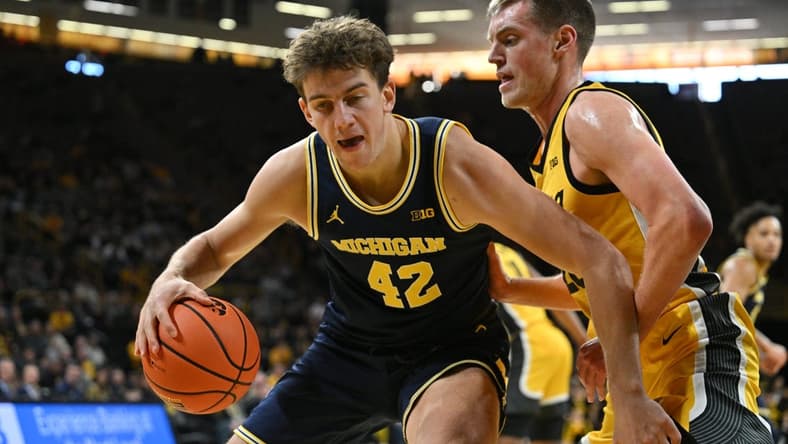 Dec 10, 2023; Iowa City, Iowa, USA; Michigan Wolverines forward Will Tschetter (42) controls the ball as Iowa Hawkeyes forward Payton Sandfort (20) defends during the first half at Carver-Hawkeye Arena. Mandatory Credit: Jeffrey Becker-USA TODAY Sports