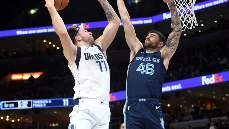 Dec 11, 2023; Memphis, Tennessee, USA; Dallas Mavericks guard Luka Doncic (77) drives to the basket as Memphis Grizzlies guard John Konchar (46) defends during the first half at FedExForum. Mandatory Credit: Petre Thomas-USA TODAY Sports