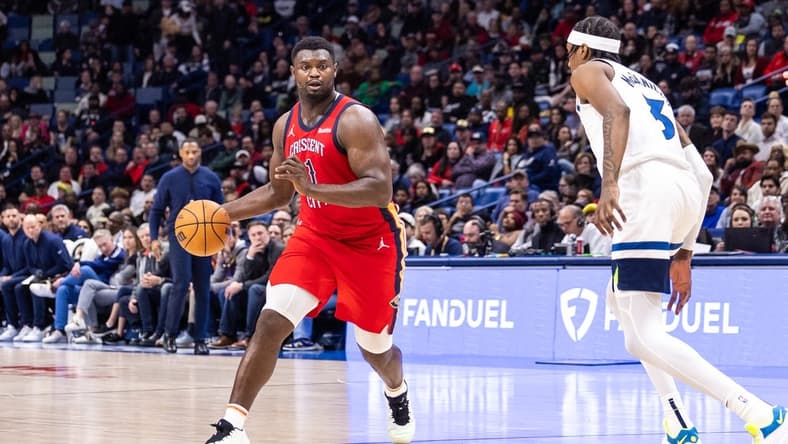 Dec 11, 2023; New Orleans, Louisiana, USA; New Orleans Pelicans forward Zion Williamson (1) dribbles against Minnesota Timberwolves forward Jaden McDaniels (3) during the second half at the Smoothie King Center. Mandatory Credit: Stephen Lew-USA TODAY Sports