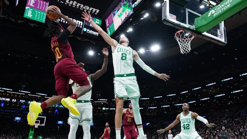 Dec 12, 2023; Boston, Massachusetts, USA; Boston Celtics center Kristaps Porzingis (8) and guard Jrue Holiday (4) defend against Cleveland Cavaliers guard Darius Garland (10) in the second quarter at TD Garden. Mandatory Credit: David Butler II-USA TODAY Sports