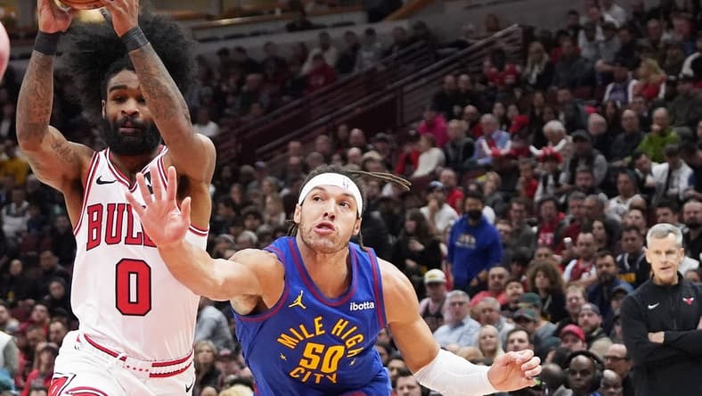 Dec 12, 2023; Chicago, Illinois, USA; Denver Nuggets forward Aaron Gordon (50) defends Chicago Bulls guard Coby White (0) during the first half at United Center. Mandatory Credit: David Banks-USA TODAY Sports