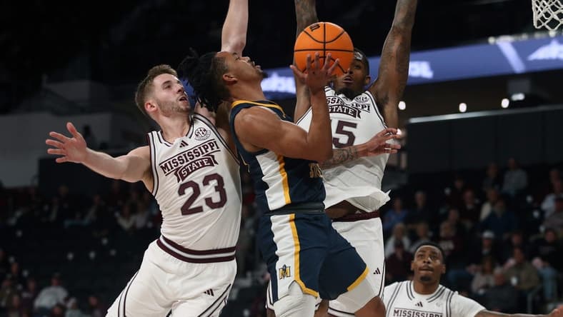 Dec 13, 2023; Starkville, Mississippi, USA; Murray State Racers guard JaCobi Wood (24) drives to the basket as Mississippi State Bulldogs guard Andrew Taylor (23) and forward Jimmy Bell Jr. (15) defends during the first half at Humphrey Coliseum. Mandatory Credit: Petre Thomas-USA TODAY Sports