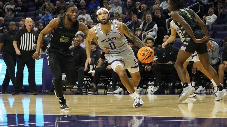 Dec 13, 2023; Evanston, Illinois, USA; Chicago State Cougars guard Brent Davis (12) defends Northwestern Wildcats guard Boo Buie (0) during the first half at Welsh-Ryan Arena. Mandatory Credit: David Banks-USA TODAY Sports