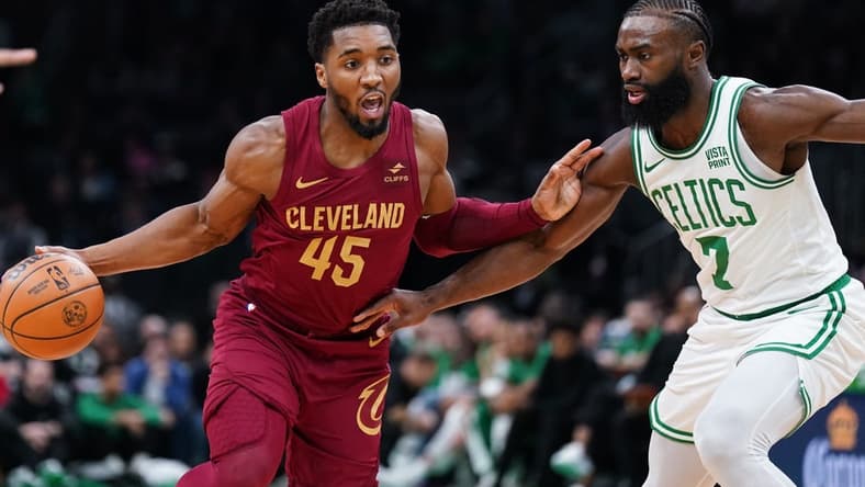 Dec 14, 2023; Boston, Massachusetts, USA; Cleveland Cavaliers guard Donovan Mitchell (45) drives the ball against Boston Celtics guard Jaylen Brown (7) in the first quarter at TD Garden. Mandatory Credit: David Butler II-USA TODAY Sports