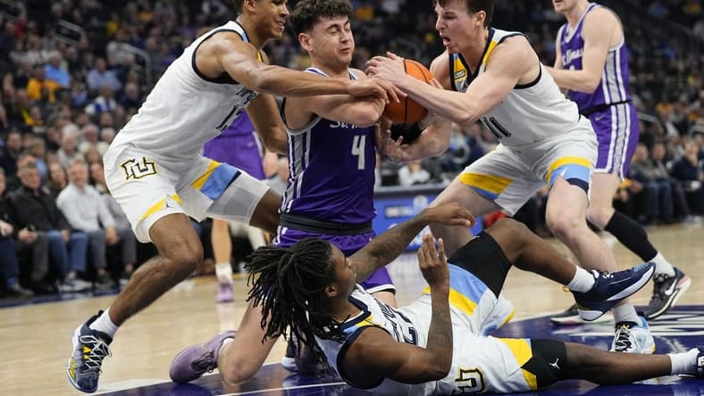 Dec 14, 2023; Milwaukee, Wisconsin, USA;  St. Thomas (MN) Tommies forward Brooks Allen (4) battles Marquette Golden Eagles forward Oso Ighodaro (13) and guard Tyler Kolek (11) for control of the ball during the first half at Fiserv Forum. Mandatory Credit: Jeff Hanisch-USA TODAY Sports
