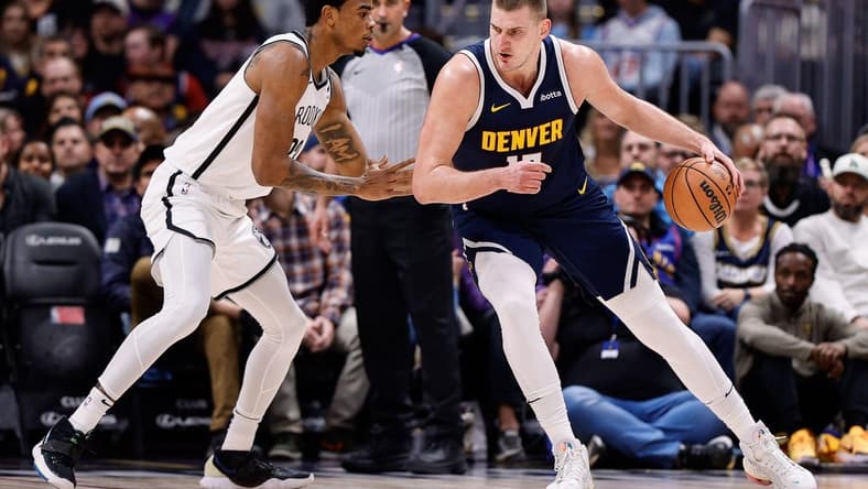 Dec 14, 2023; Denver, Colorado, USA; Denver Nuggets center Nikola Jokic (15) controls the ball as Brooklyn Nets center Nic Claxton (33) guards in the first quarter at Ball Arena. Mandatory Credit: Isaiah J. Downing-USA TODAY Sports