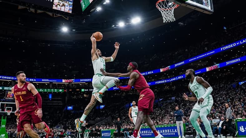 Dec 14, 2023; Boston, Massachusetts, USA; Boston Celtics forward Jayson Tatum (0) drives to the basket against Cleveland Cavaliers guard Caris LeVert (3) in the second half at TD Garden. Mandatory Credit: David Butler II-USA TODAY Sports