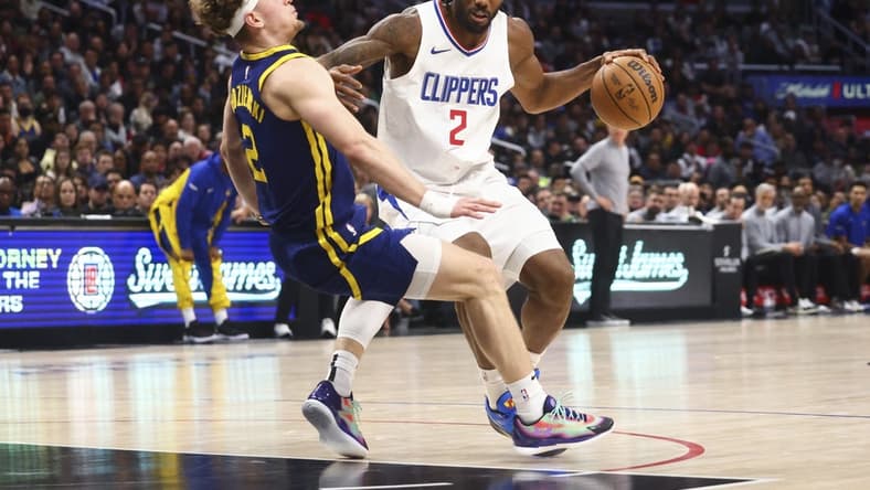 Dec 14, 2023; Los Angeles, California, USA; LA Clippers forward Kawhi Leonard (2) dribbles against Golden State Warriors guard Brandin Podziemski (2) and draws an offensive foul during the second half of the game at Crypto.com Arena. Mandatory Credit: Jessica Alcheh-USA TODAY Sports