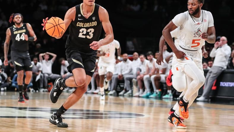 Dec 10, 2023; Brooklyn, New York, USA; Colorado Buffaloes forward Tristan da Silva (23) and Miami (Fl) Hurricanes guard Wooga Poplar (5) at Barclays Center. Mandatory Credit: Wendell Cruz-USA TODAY Sports