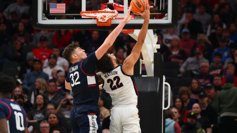 Dec 15, 2023; Seattle, Washington, USA; Connecticut Huskies center Donovan Clingan (32) blocks a shot attempt by Gonzaga Bulldogs forward Anton Watson (22) during the second half at Climate Pledge Arena. Mandatory Credit: Steven Bisig-USA TODAY Sports
