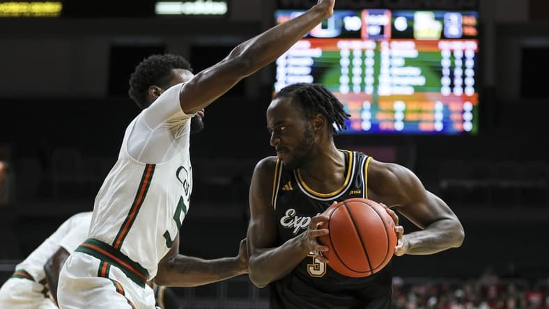 Dec 16, 2023; Coral Gables, Florida, USA; La Salle Explorers guard Anwar Gill (3) protects the basketball from Miami Hurricanes guard Wooga Poplar (5) during the first half at Watsco Center. Mandatory Credit: Sam Navarro-USA TODAY Sports
