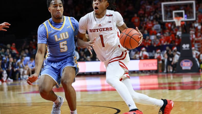 Dec 16, 2023; Piscataway, New Jersey, USA; Rutgers Scarlet Knights guard Jamichael Davis (1) drives to the basket as Long Island Sharks guard Andre Washington (5) defends during the second half at Jersey Mike's Arena. Mandatory Credit: Vincent Carchietta-USA TODAY Sports