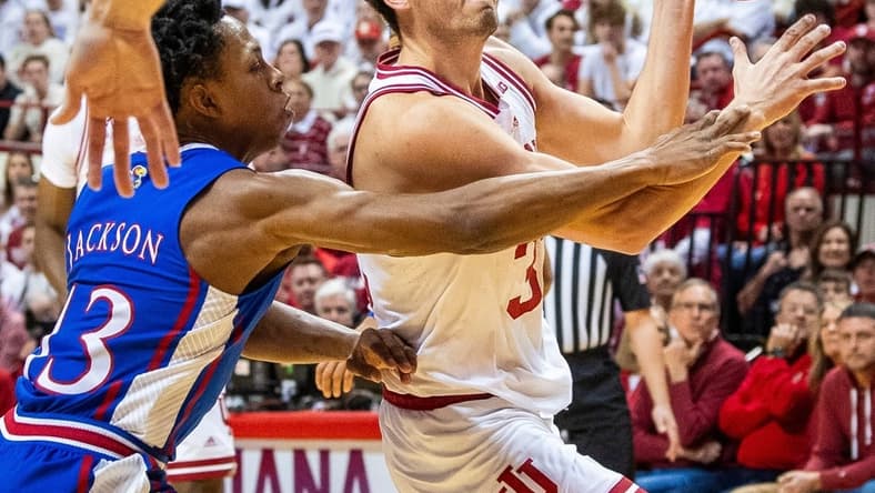 Indiana's Trey Galloway (32) is fouled by Kansas' Elmarko Jackson (13) during the first half of the Indiana versus Kansas men's basketball game at Simon Skjodt Assembly Hall on Saturday, Dec. 16, 2023.