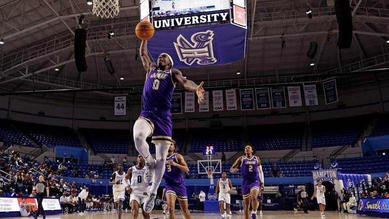 Dec 16, 2023; Hampton, Virginia, USA; James Madison Dukes guard Xavier Brown (0) dunks the ball against the Hampton Pirates during the second half at Hampton Convocation Center. Mandatory Credit: Peter Casey-USA TODAY Sports