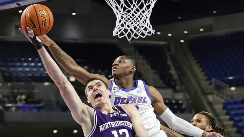 Dec 16, 2023; Chicago, Illinois, USA; Northwestern Wildcats guard Brooks Barnhizer (13) goes to the basket against DePaul Blue Demons guard Elijah Fisher (22) during the first half at Wintrust Arena. Mandatory Credit: Kamil Krzaczynski-USA TODAY Sports