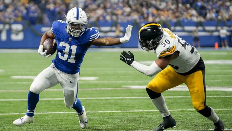 Indianapolis Colts running back Tyler Goodson (31) reaches to stiff arm Pittsburgh Steelers linebacker Elandon Roberts (50) as he rushes toward the end zone Saturday, Dec. 16, 2023, during a game against the Pittsburgh Steelers at Lucas Oil Stadium in Indianapolis.