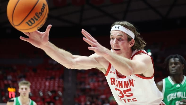 Dec 16, 2023; Salt Lake City, Utah, USA; Utah Utes center Branden Carlson (35) reaches for a rebound against the Utah Valley Wolverines during the second half at Jon M. Huntsman Center. Mandatory Credit: Rob Gray-USA TODAY Sports