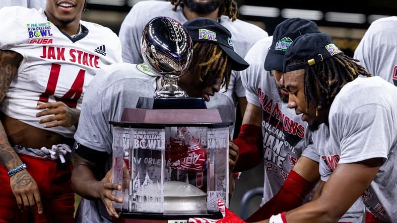 Dec 16, 2023; New Orleans, LA, USA; Jacksonville State Gamecocks hold up the game trophy after the game against the Louisiana-Lafayette Ragin Cajuns at the Caesars Superdome. Mandatory Credit: Stephen Lew-USA TODAY Sports