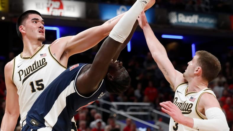 Purdue Boilermakers center Zach Edey (15), Arizona Wildcats center Oumar Ballo (11) and Purdue Boilermakers guard Braden Smith (3) fight for a rebound during the NCAA men s basketball game, Saturday, Dec. 16, 2023, at Gainbridge Fieldhouse in Indianapolis. Purdue Boilermakers won 92-84.