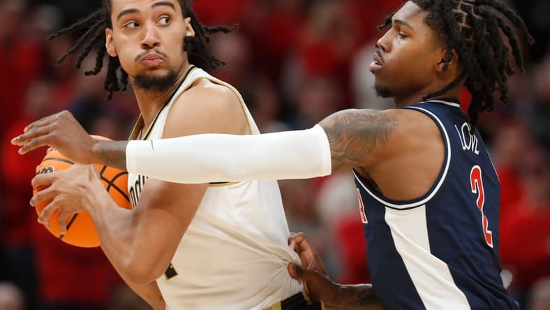 Purdue Boilermakers forward Trey Kaufman-Renn (4) is defended by Arizona Wildcats guard Caleb Love (2) during the NCAA men s basketball game, Saturday, Dec. 16, 2023, at Gainbridge Fieldhouse in Indianapolis. Purdue Boilermakers won 92-84.