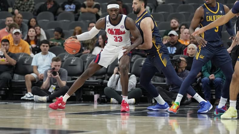 Dec 16, 2023; San Antonio, Texas, USA; Mississippi Rebels forward Moussa Cisse (33) is defended by California Golden Bears forward Fardaws Aimaq in the first half at the Frost Bank Center. Mandatory Credit: Daniel Dunn-USA TODAY Sports