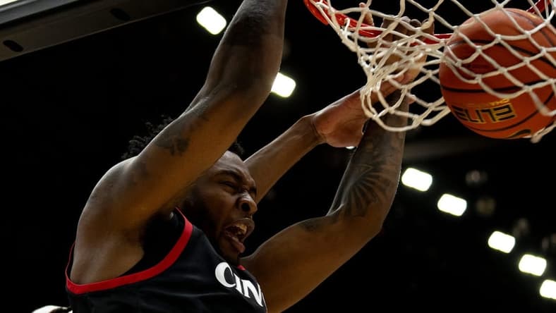Cincinnati Bearcats forward Jamille Reynolds (13) dunks around Dayton Flyers forward DaRon holmes II (15) in the first half of the NCAA men's basketball game between the Dayton Flyers and Cincinnati Bearcats at Heritage Bank Center in Cincinnati on Saturday, Dec. 16, 2023.