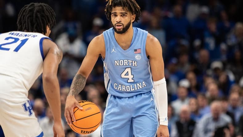 Dec 16, 2023; Atlanta, Georgia, USA North North Carolina Tar Heels guard RJ Davis (4) dribbles the ball against UCLA Bruins forward Evan Manjikian (21) during the second half at State Farm Arena. Mandatory Credit: Jordan Godfree-USA TODAY Sports