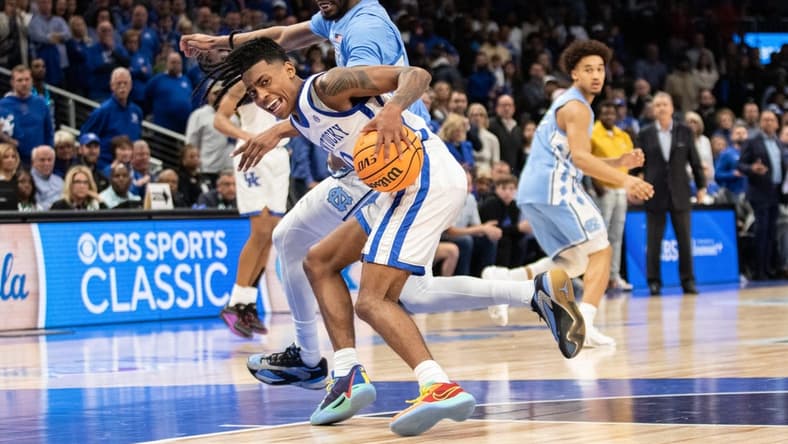 Dec 16, 2023; Atlanta, Georgia, USA; Kentucky Wildcats guard Rob Dillingham (0) dribbles the ball against North Carolina Tar Heels forward Jae'Lyn Withers (24) during the second half at State Farm Arena. Mandatory Credit: Jordan Godfree-USA TODAY Sports