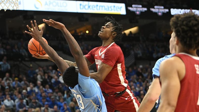 Dec 16, 2023; Omaha, Nebraska, USA; Alabama Crimson Tide forward Nick Pringle (23) drives against Creighton Bluejays center Fredrick King (33) in the first half at CHI Health Center Omaha. Mandatory Credit: Steven Branscombe-USA TODAY Sports