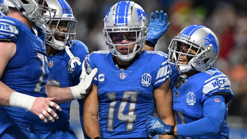 Dec 16, 2023; Detroit, Michigan, USA; Detroit Lions wide receiver Amon-Ra St. Brown (14) celebrates in the end zone with wide receiver Kalif Raymond (right) and wide receiver Jameson Williams (9) and center Frank Ragnow (left) after scoring a touchdown against the Denver Broncos in the second quarter at Ford Field. Mandatory Credit: Lon Horwedel-USA TODAY Sports
