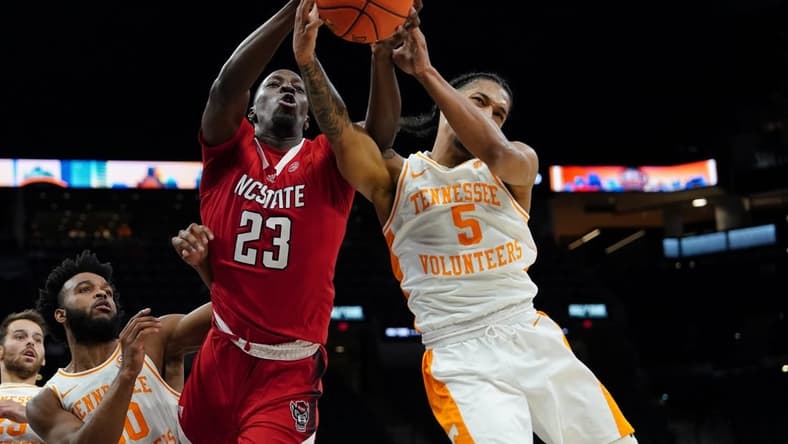 Dec 16, 2023; San Antonio, Texas, USA; North Carolina State Wolfpack forward Mohamed Diarra (23) and Tennessee Volunteers guard Zakai Zeigler (5) go after the ball in the first half at the Frost Bank Center. Mandatory Credit: Daniel Dunn-USA TODAY Sports