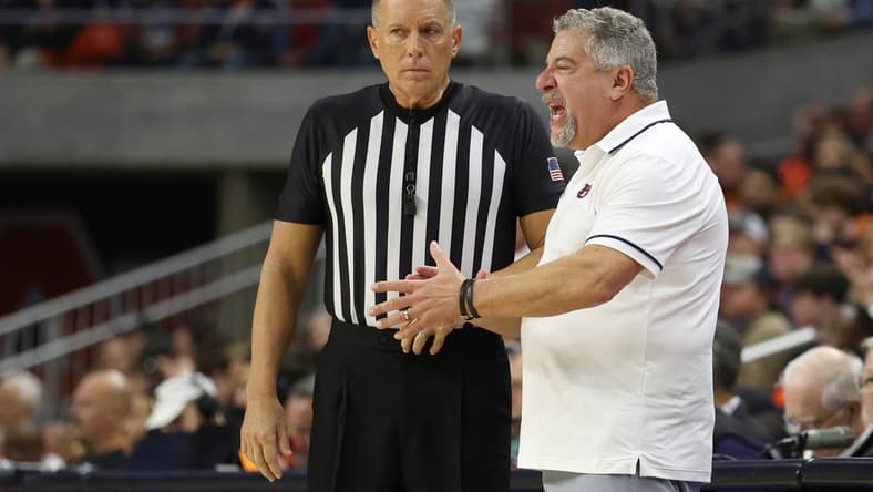 Dec 17, 2023; Auburn, Alabama, USA; Auburn Tigers head coach Bruce Pearl talks to a game official during the second half against the USC Trojans at Neville Arena. Mandatory Credit: John Reed-USA TODAY Sports
