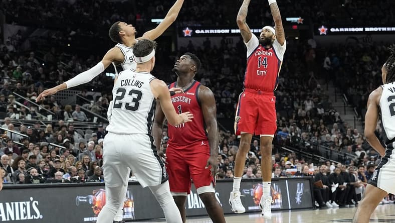 Dec 17, 2023; San Antonio, Texas, USA; New Orleans Pelicans Brandon Ingram (14) shoots over San Antonio Spurs forward Victor Wembanyama (1) during the first half at Frost Bank Center. Mandatory Credit: Scott Wachter-USA TODAY Sports