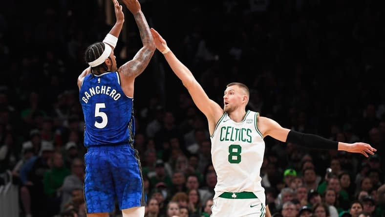 Dec 17, 2023; Boston, Massachusetts, USA; Orlando Magic forward Paolo Banchero (5) shoots the ball over Boston Celtics center Kristaps Porzingis (8) during the second half at TD Garden. Mandatory Credit: Bob DeChiara-USA TODAY Sports