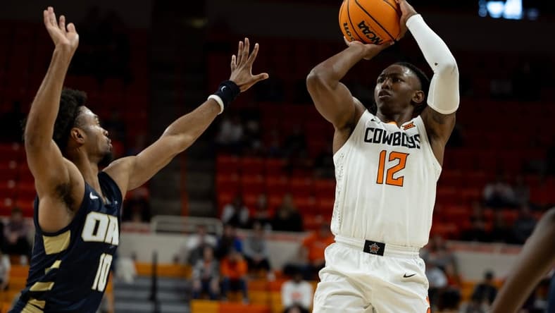 Dec 17, 2023; Stillwater, Okla, USA ; Oklahoma State Cowboys guard Javon Small (12) shoots over Oral Roberts Golden Eagles guard Issac McBride (10) in the first half of an NCAA basketball game at Gallagher Iba arena. Mandatory Credit: Mitch Alcala-The Oklahoman